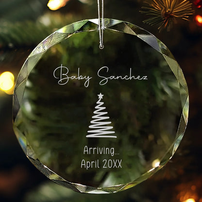 Personalized glass ornament engraved with “Baby [Name]” and due date featuring Christmas tree design.