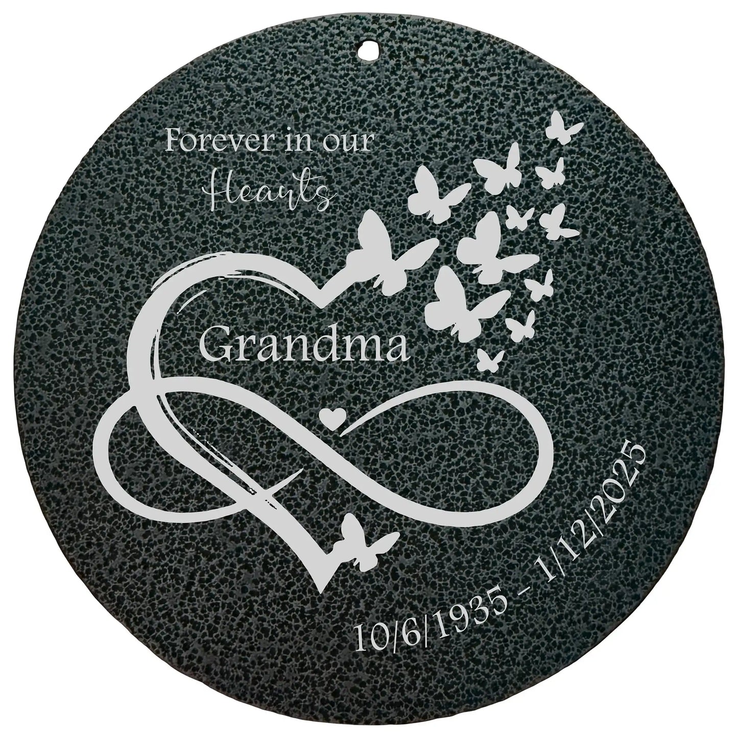 Wind Chime memorial plaque disk with butterfly design, heart, and infinity symbol on a dark background.