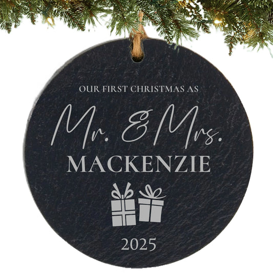 Slate ornament engraved with “Our First Christmas as Mr. & Mrs.,” last name, gift icons, and year.