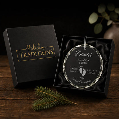 Footprints personalized baby's first Christmas glass ornament arrives in a black Holiday Traditions gift box, ready to give