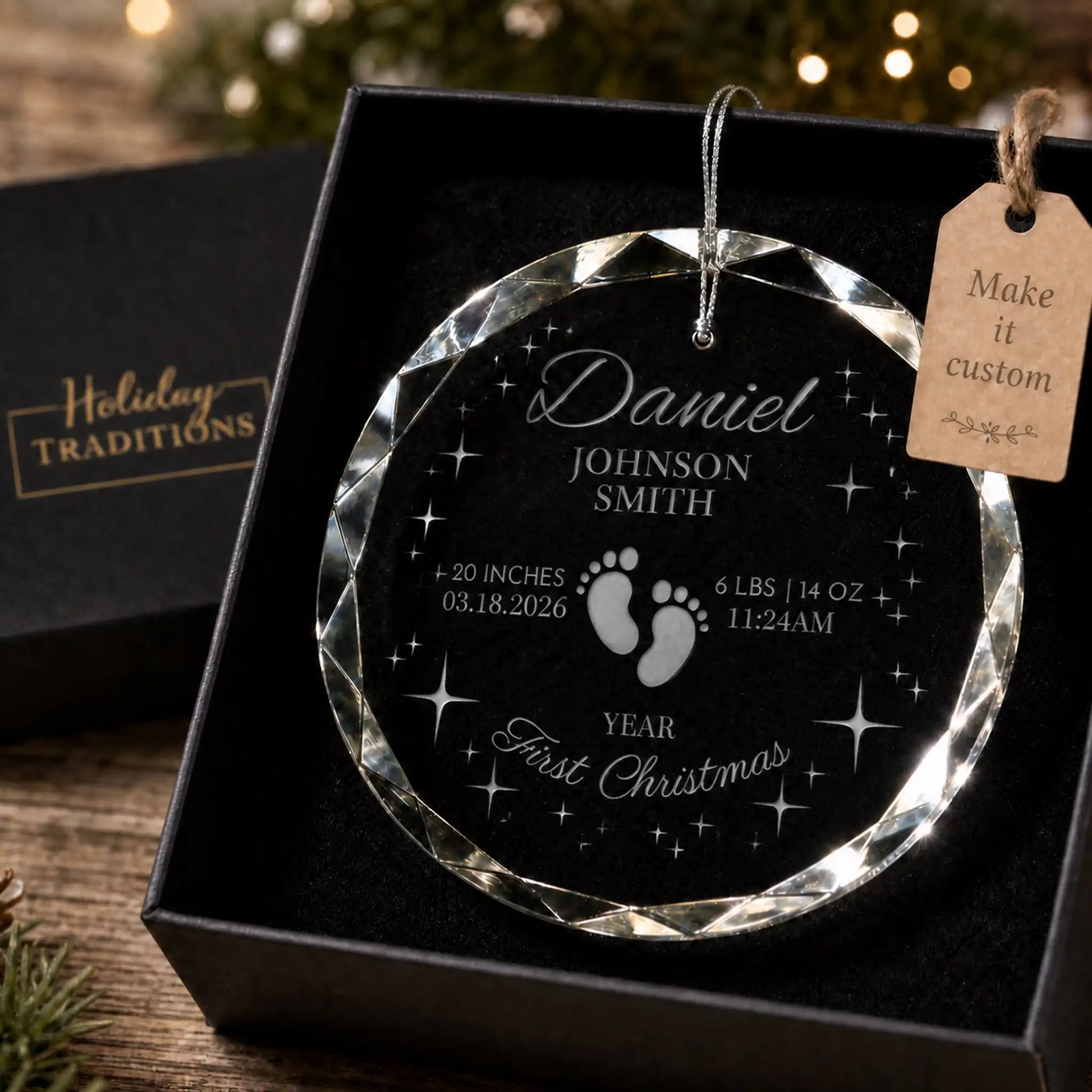 Baby's first Christmas personalized glass ornament with footprints and stars, laser engraved with baby's name, birth stats and year, shown in its black gift box