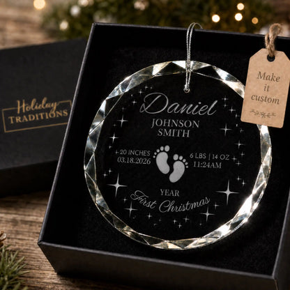 Baby's first Christmas personalized glass ornament with footprints and stars, laser engraved with baby's name, birth stats and year, shown in its black gift box