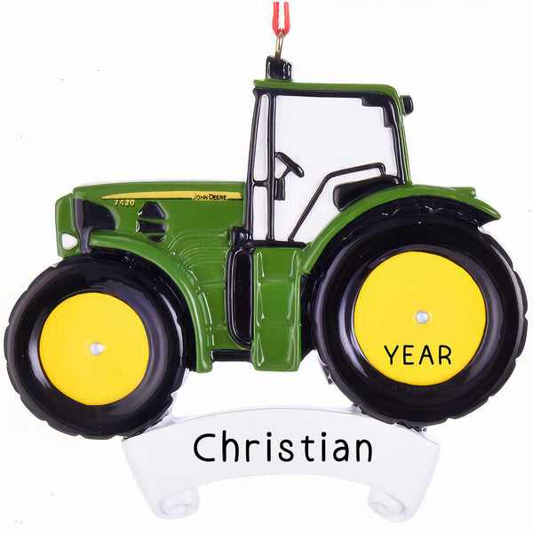 A personalized John Deere tractor Christmas ornament in green and yellow, with a ribbon loop for hanging and spaces marked 'YEAR' and 'Christian' for customization.