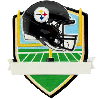 Black Pittsburgh Steelers football helmet with a logo on a decorative plaque of a football field