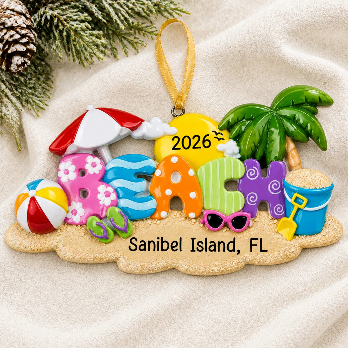 Personalized beach fun christmas ornament laid on a soft white knit blanket