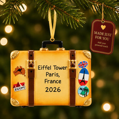 Tan travel suitcase christmas ornament hanging on a lit Christmas tree with a Made Just For You gift tag