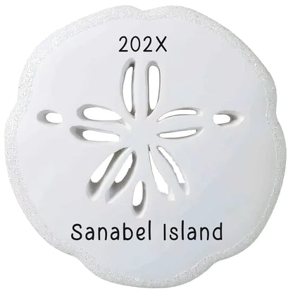 Personalized sand dollar Christmas ornament with a textured white sand dollar, laser engraved with a custom message and the year.