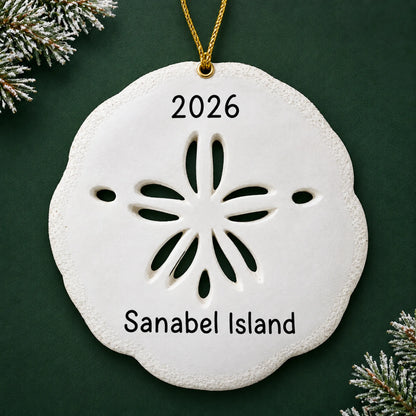 Personalized sand dollar christmas ornament, a white sand dollar, on a dark green pine background