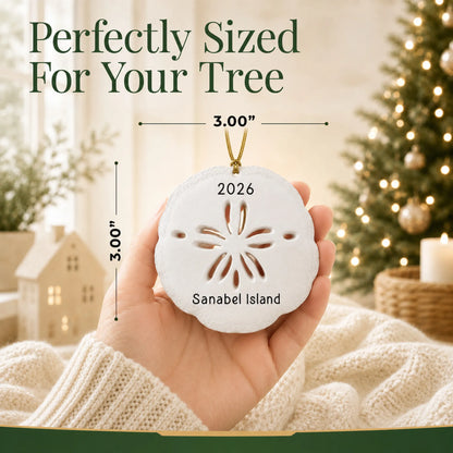 Size guide: the personalized sand dollar christmas ornament is 3.00 in wide by 3.00 in tall, shown in hand