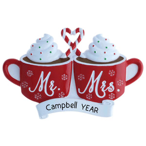 Personalized Mr & Mrs ornament with two hot cocoa mugs, banner engraved on the front.