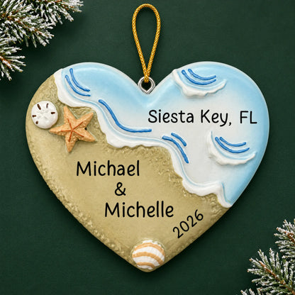 Personalized name in sand beach christmas ornament on a dark green pine background