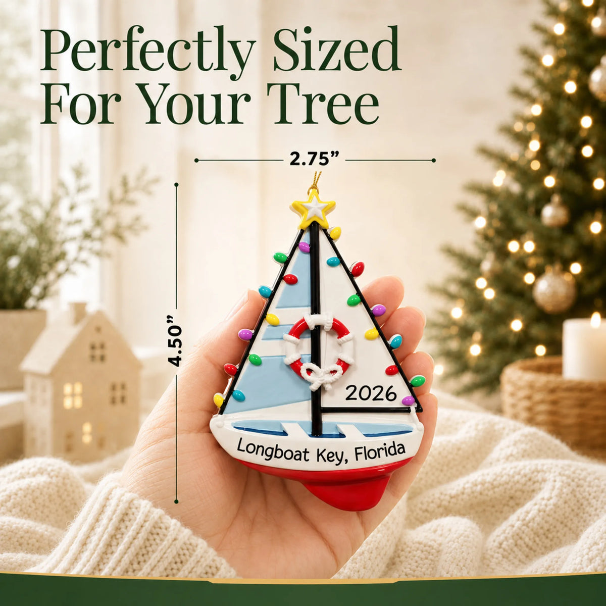 Size guide: the personalized lighted sailboat christmas ornament is 2.75 in wide by 4.50 in tall, shown in hand