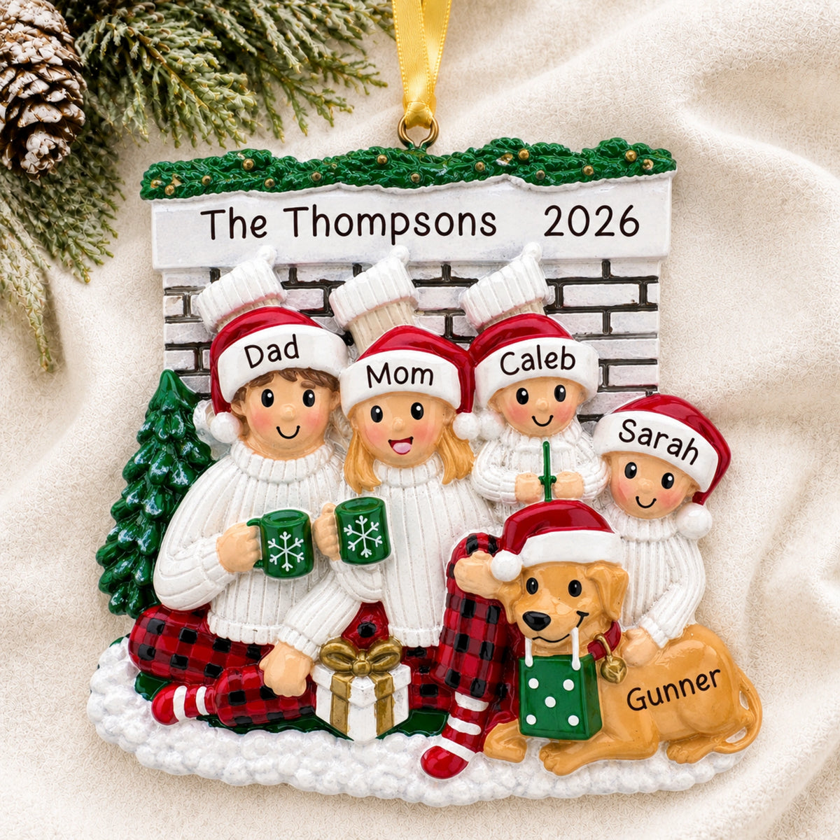 Personalized family of 4 with dog fireplace Christmas ornament hanging on a tree branch with names and 2026