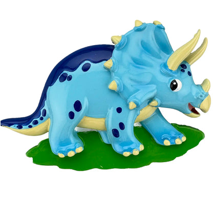 Toy triceratops dinosaur on a green base with a white background