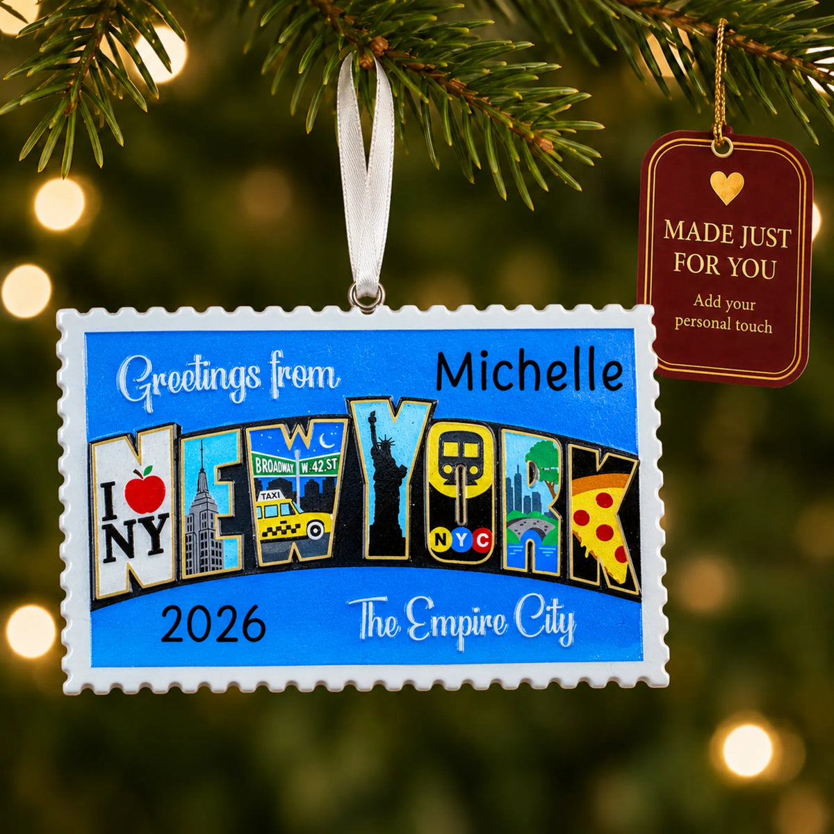 New York City postcard christmas ornament hanging on a lit Christmas tree with a Made Just For You gift tag