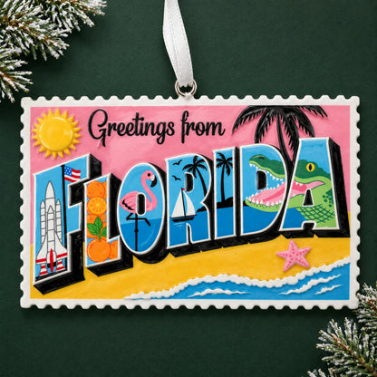 Personalized Florida postcard christmas ornament, a Greetings from Florida postcard, on a dark green pine background