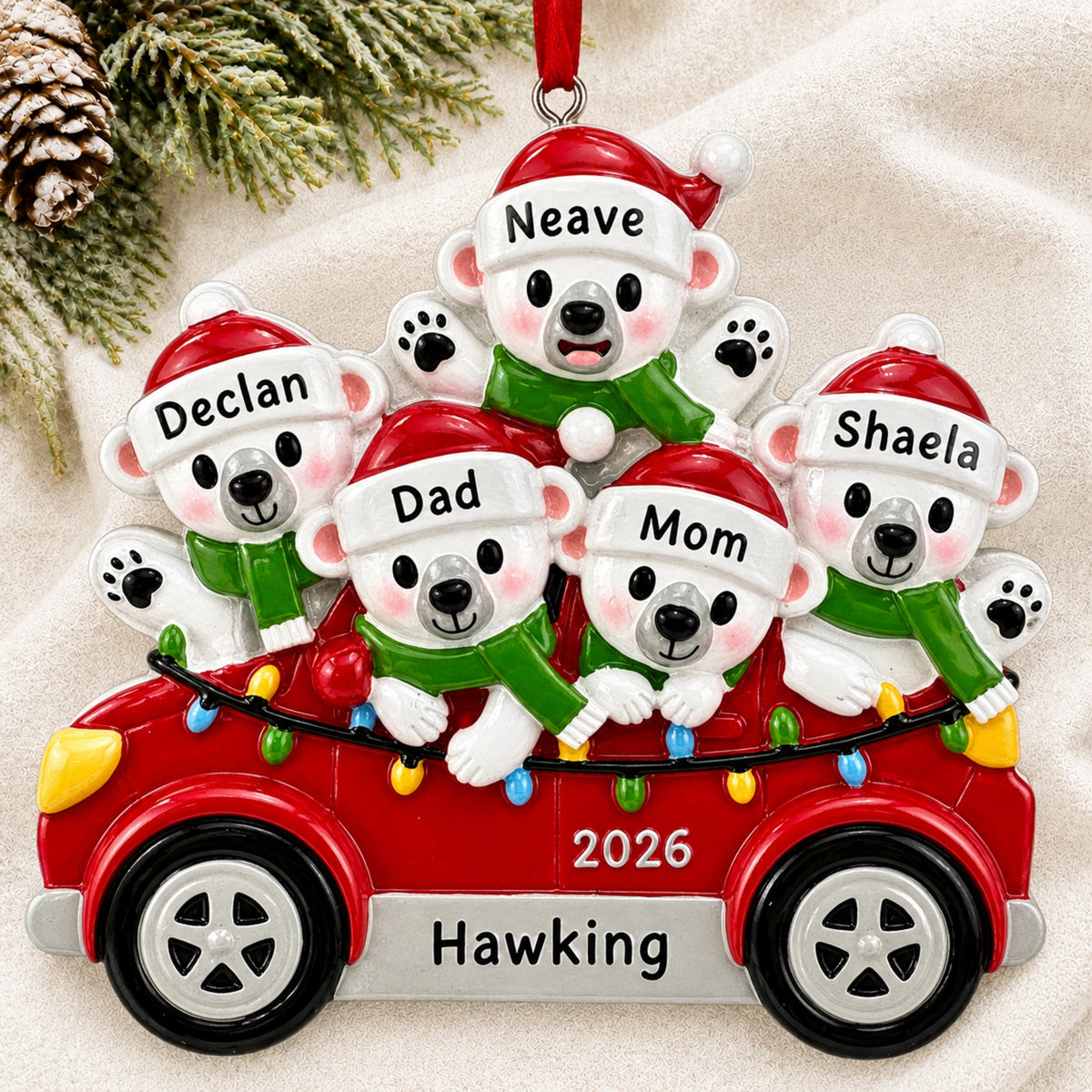 Personalized polar bears family of 5 Christmas ornament hanging on a tree branch with names and 2026