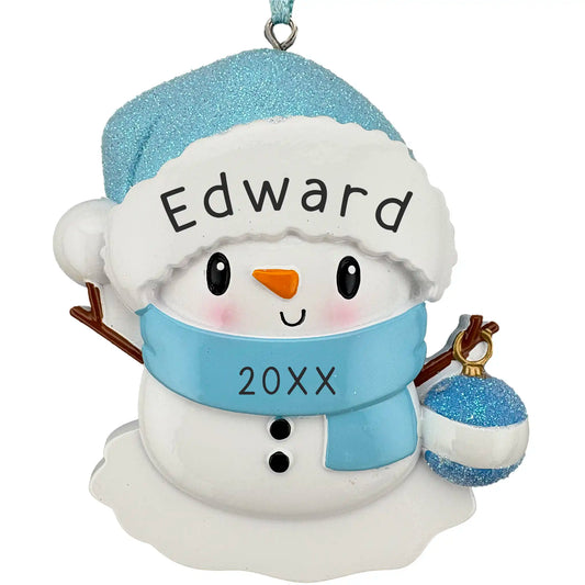 Personalized snowman ornament with blue hat and scarf, holding a blue ornament, on a white background.