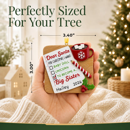 Personalized big sister Christmas ornament held in hand, about 3.4 inches wide for your tree