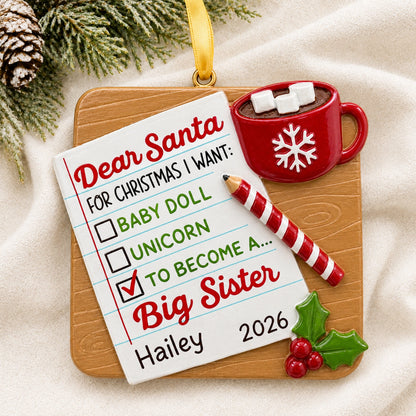 Personalized big sister Christmas ornament as a Dear Santa note hanging on a tree branch