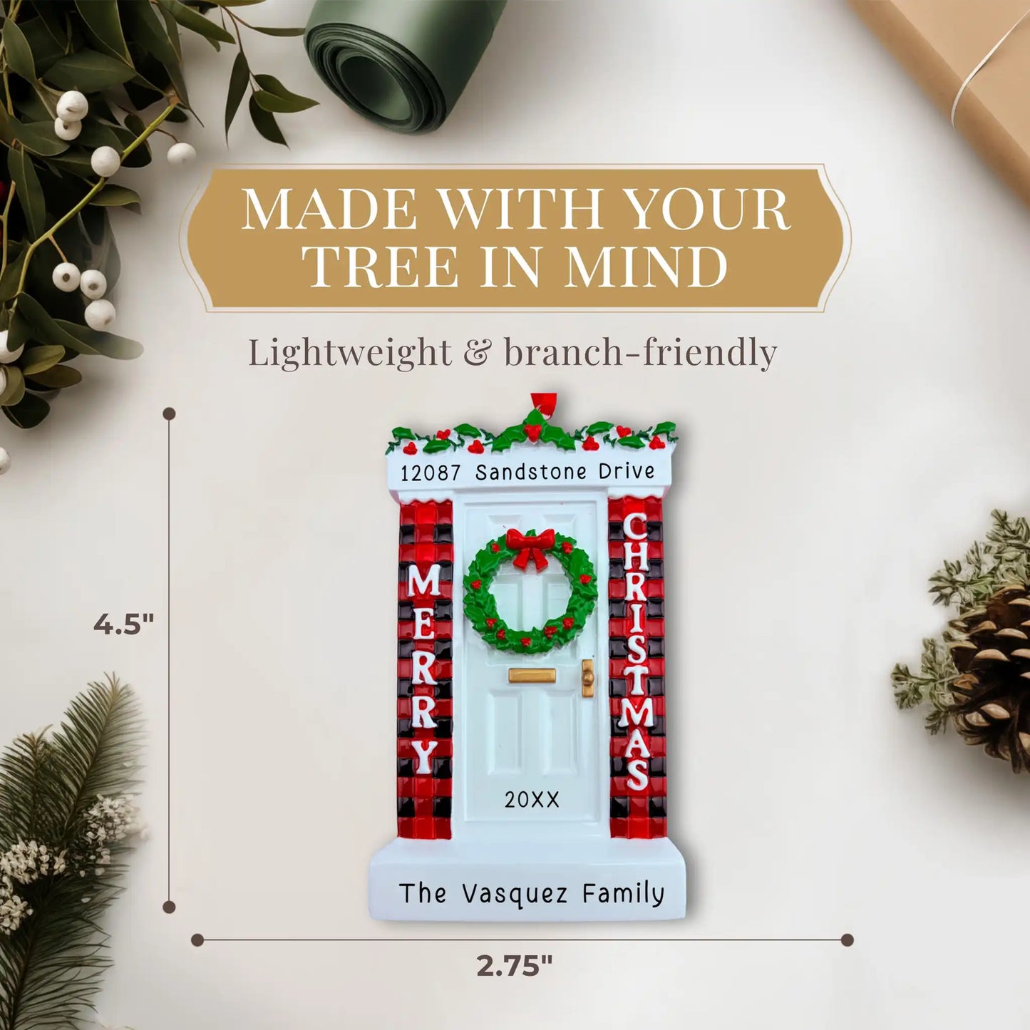 Christmas-themed door ornament with wreath, plaid decorations, and white door. Measurement shows 4.50 by 2.75 inches.
