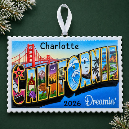 Personalized California postcard christmas ornament on a dark green pine background
