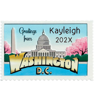 Personalized Washington DC Christmas ornament shaped like a postage stamp with the Capitol, Washington Monument, and cherry blossoms, message engraved on the front.