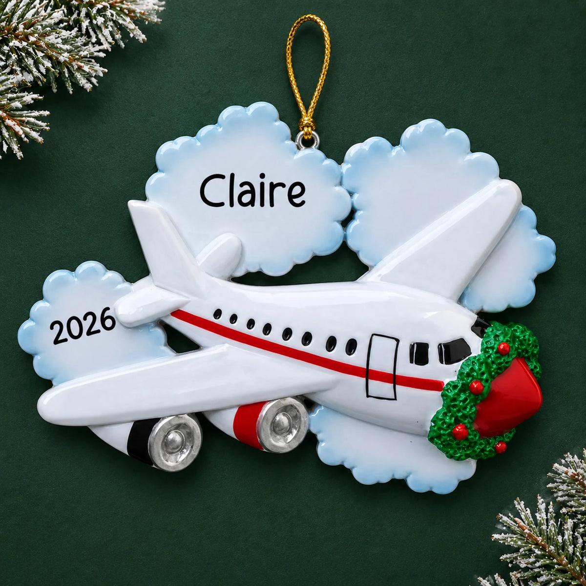 Personalized jet airplane travel christmas ornament on a dark green pine background