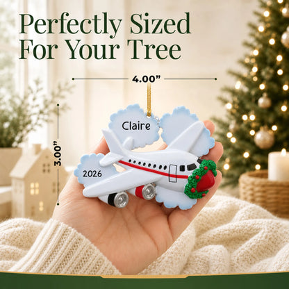 Size guide: the personalized jet airplane travel christmas ornament is 4.00 in wide by 3.00 in tall, shown in hand