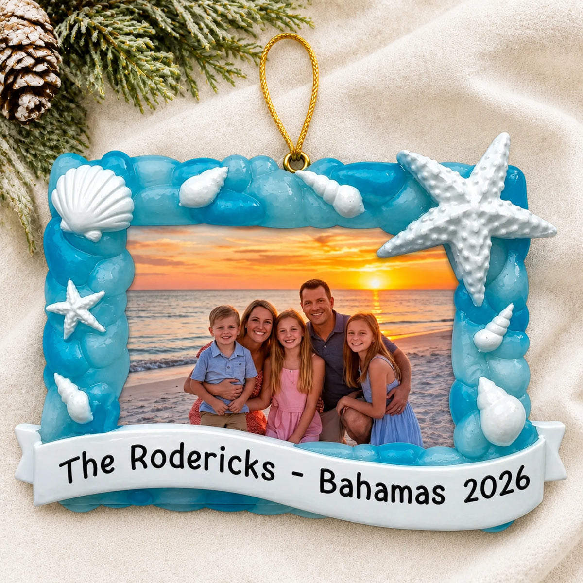 Personalized beach vacation photo frame christmas ornament laid on a soft white knit blanket