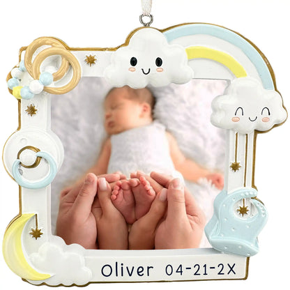 Personalized baby boy photo frame ornament with clouds, rainbow, and rattle, holding a newborn photo above a laser engraved name and birth date banner