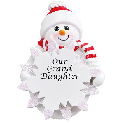 Personalized snowman ornament engraved with “Our Granddaughter,” featuring a red hat, scarf, and glitter snowflake personalized with name and year.