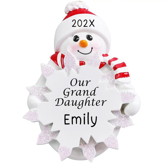 Personalized Our Granddaughter snowman ornament with Santa hat and candy cane, surrounded by white glitter snowflakes