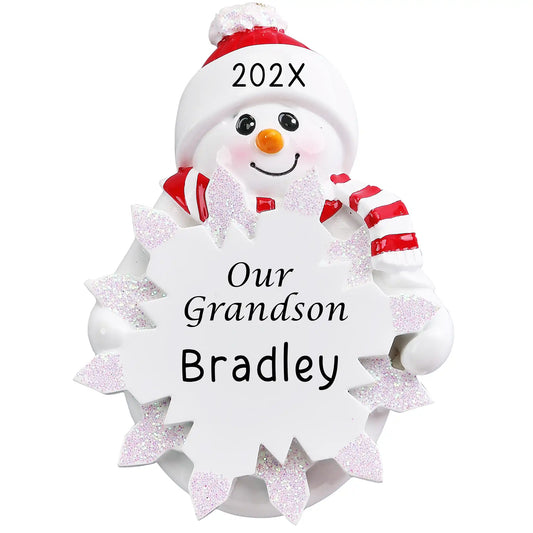 Personalized Our Grandson snowman ornament with Santa hat and candy cane, surrounded by white glitter snowflakes