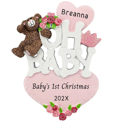 A personalized white Oh Baby Christmas ornament for a girl with a brown teddy bear, pink roses, and a glittery crown with space for custom engraved names.