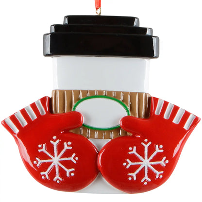 Christmas ornament shaped like a coffee cup with red mittens and snowflake designs on a white background