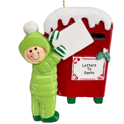 Christmas ornament of a child in a green outfit delivering letters to Santa at a red mailbox.