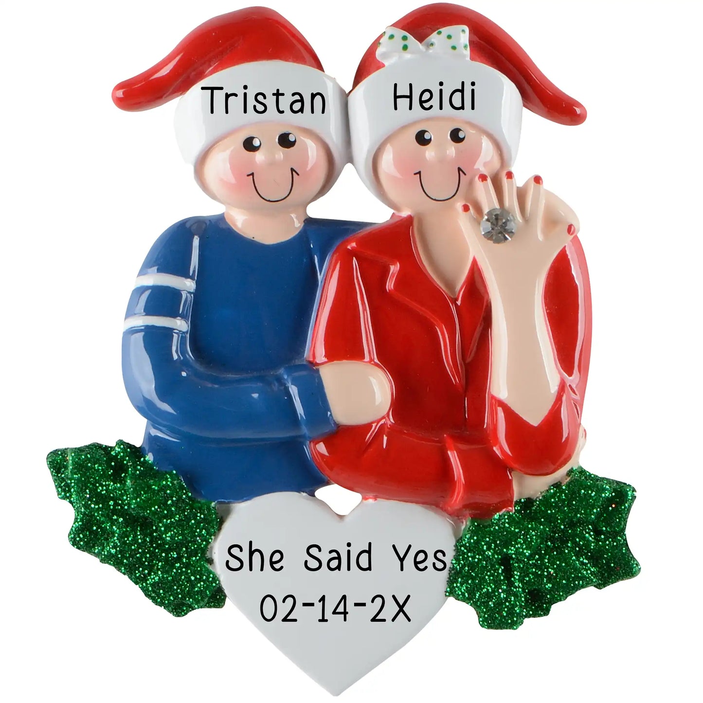 A personalized Christmas ornament of an engaged couple in Santa hats with the woman showing her engagement ring, featuring a white heart for custom engraving.