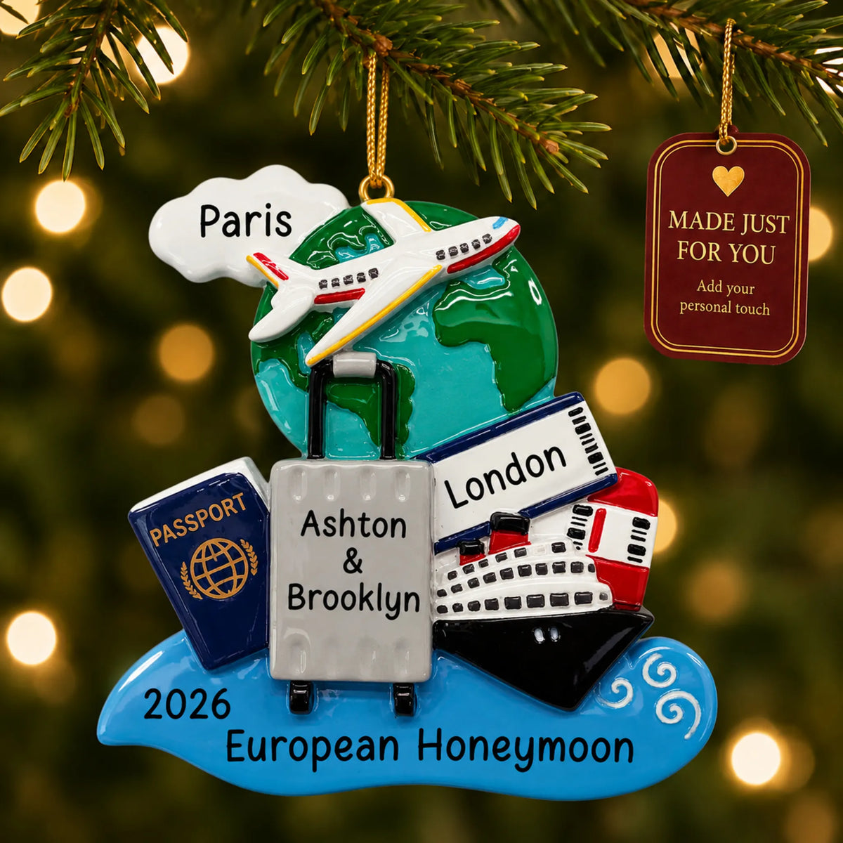 World traveler passport christmas ornament hanging on a lit Christmas tree with a Made Just For You gift tag
