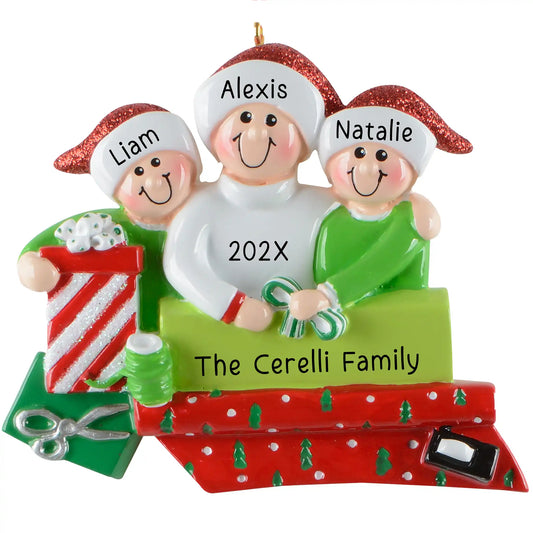 Personalized single parent with two kids Christmas ornament gift wrapping scene with banner area for custom names and year