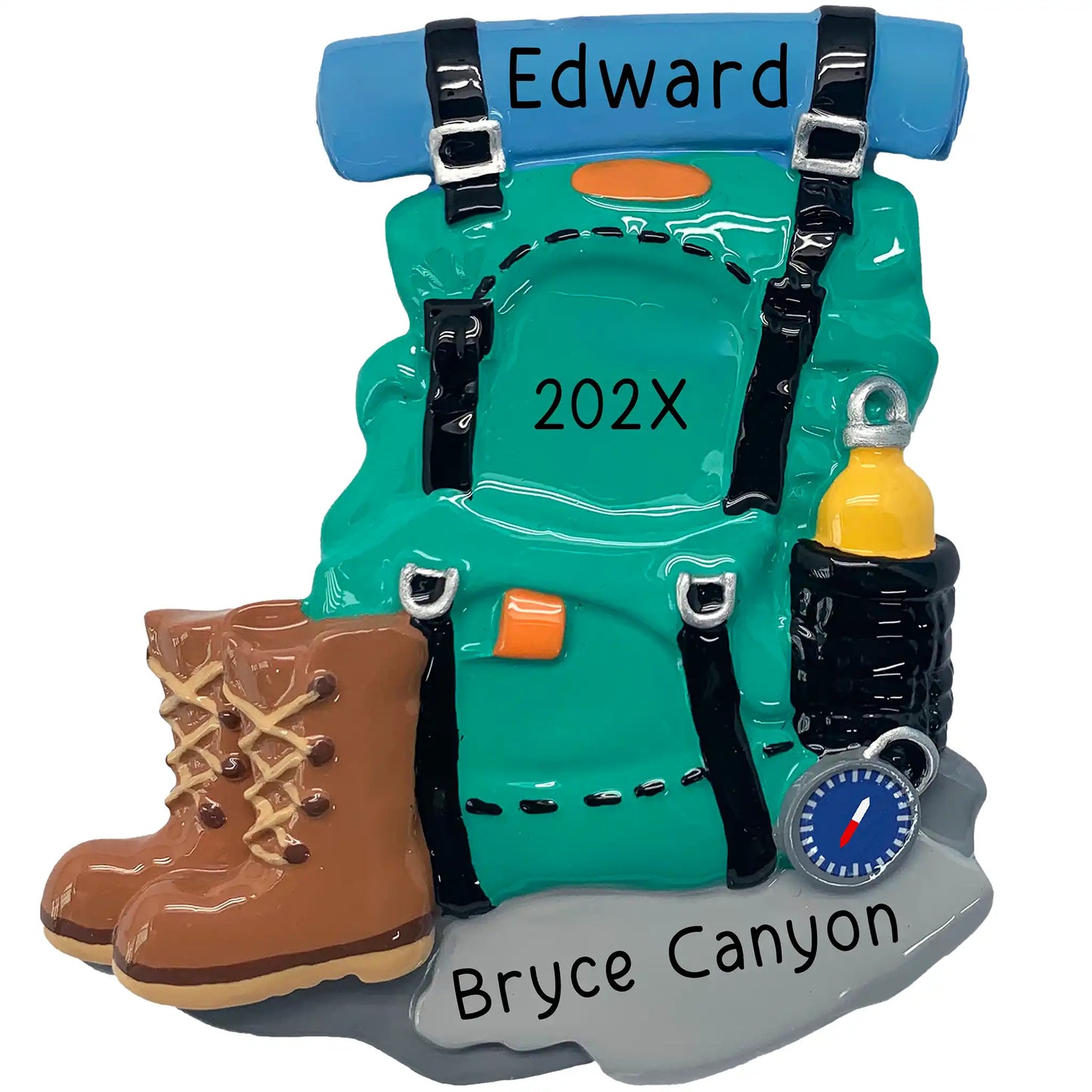 A personalized Christmas ornament of a teal hiking backpack with brown boots and a compass, featuring space for custom engraved names.