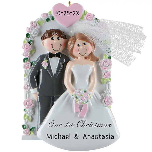 Personalized Christmas ornament of a bride and groom with a heart and floral decorations.