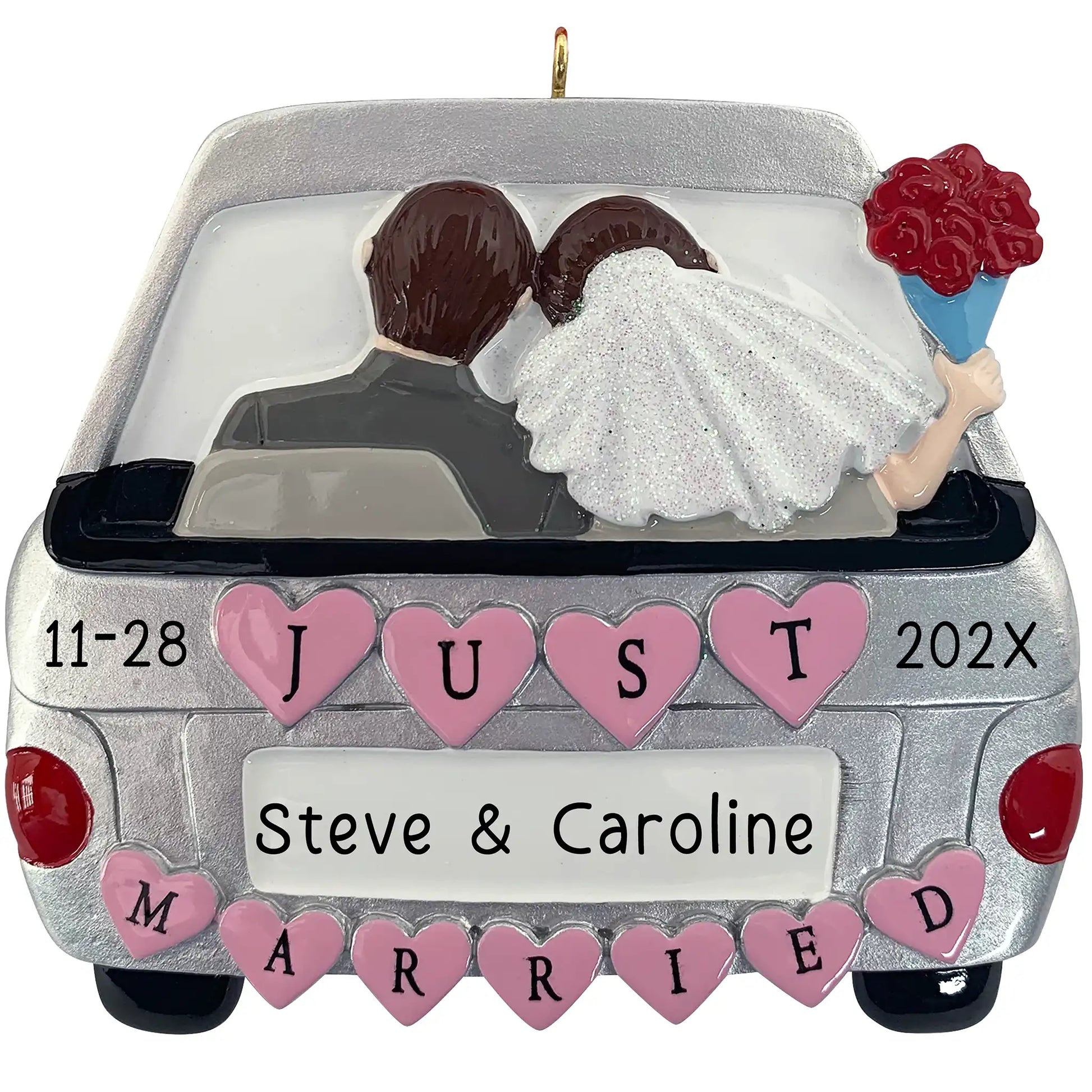 A personalized Christmas ornament of a silver getaway car with pink hearts and a bride and groom inside, featuring space for a custom name on the license plate.