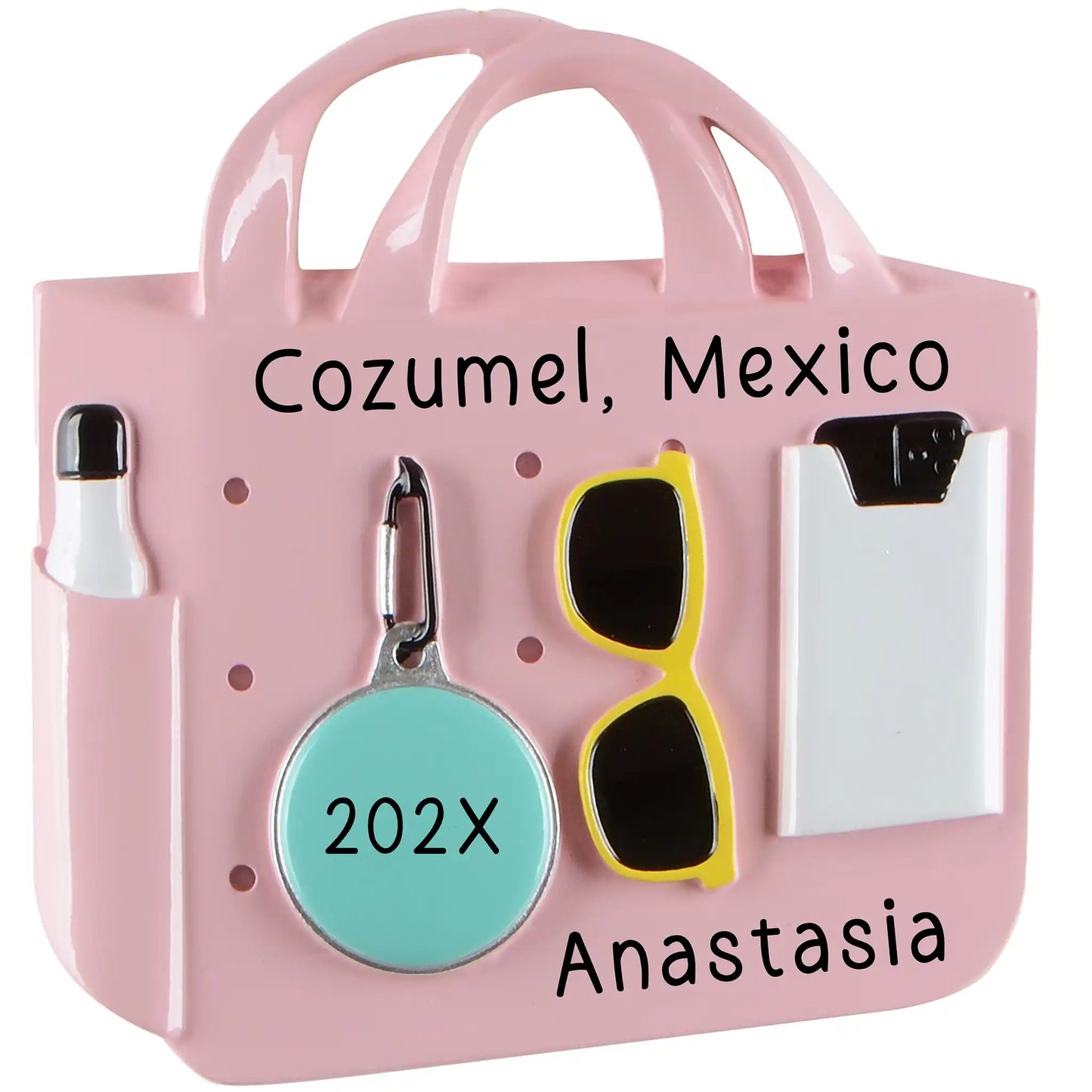 A pink beach bag Christmas ornament with sunglasses and a water bottle, featuring a custom name and vacation destination.
