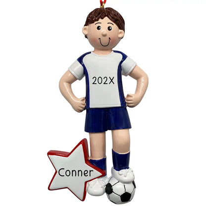 Personalized boy soccer player ornament in blue and white uniform with soccer ball at feet and red star with custom name and year engraved
