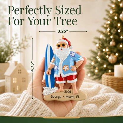 Size guide: the personalized surfing Santa christmas ornament is 3.25 in wide by 4.75 in tall, shown in hand