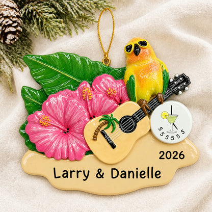 Personalized 5 O'Clock Somewhere parrot christmas ornament laid on a soft white knit blanket