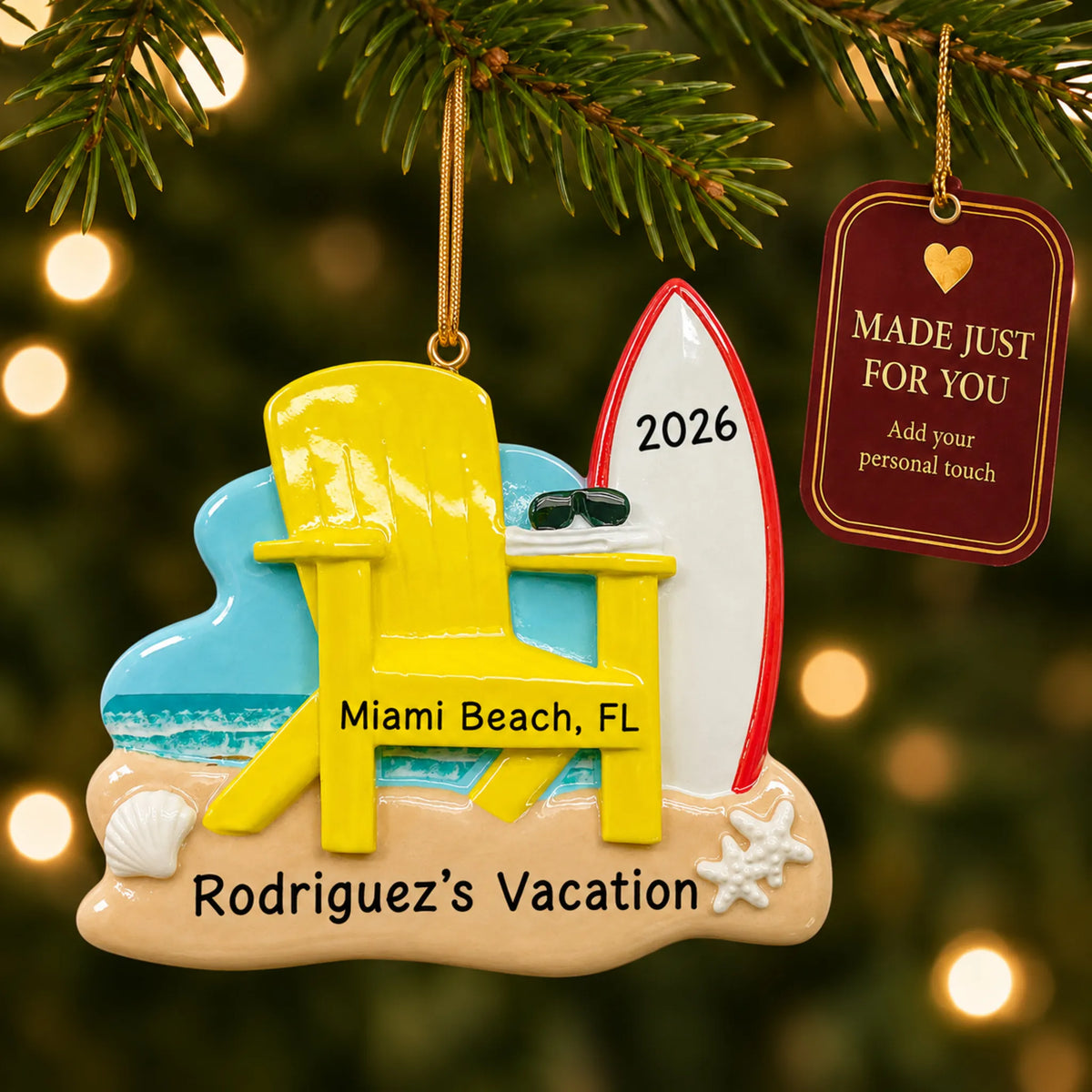Adirondack chair and surfboard christmas ornament hanging on a lit Christmas tree with a Made Just For You gift tag