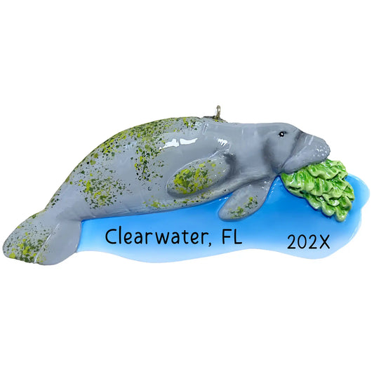 Personalized manatee ornament with gray body, green algae speckles, blue water base, and sea grass detail, custom name and year laser engraved
