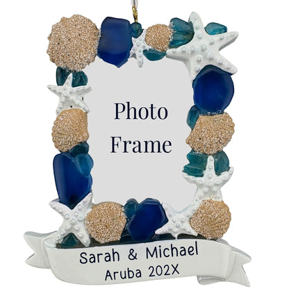 Personalized beach Christmas ornament photo frame with starfish, shells, and sea glass around a vacation photo and a laser engraved two line banner